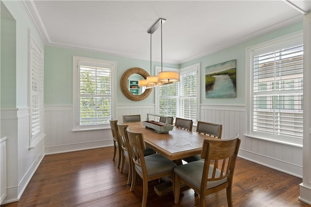 dining area with crown molding, wainscoting, and wood finished floors