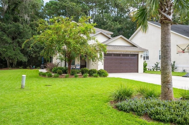 view of front of property featuring a front lawn and a garage