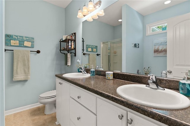 1067 Tidal Dr SE, Townsend, GA 31331 - bathroom featuring a stall shower, double vanity, toilet, baseboards, and tile patterned flooring