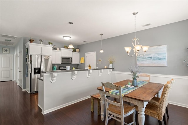 1067 Tidal Dr SE, Townsend, GA 31331 - dining room with dark wood-style floors, baseboards, and a chandelier