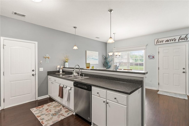 1067 Tidal Dr SE, Townsend, GA 31331 - kitchen with stainless steel dishwasher, a sink, a peninsula, dark countertops, and white cabinets