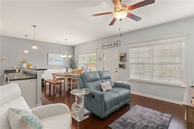 1067 Tidal Dr SE, Townsend, GA 31331 - living room featuring ceiling fan, baseboards, dark wood finished floors, and a chandelier