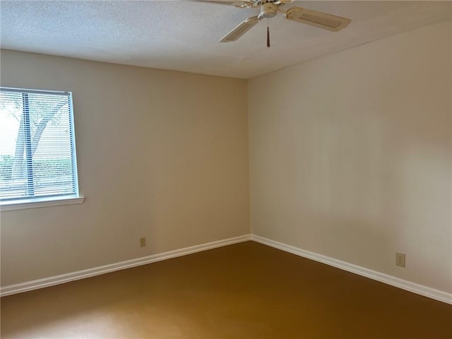 empty room featuring baseboards, a textured ceiling, and ceiling fan