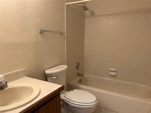 bathroom featuring tub / shower combination, toilet, and vanity