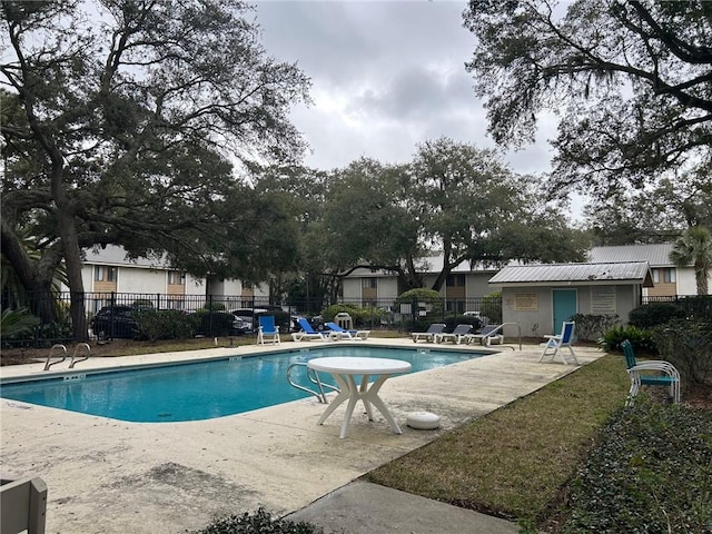 community pool featuring a patio area and fence