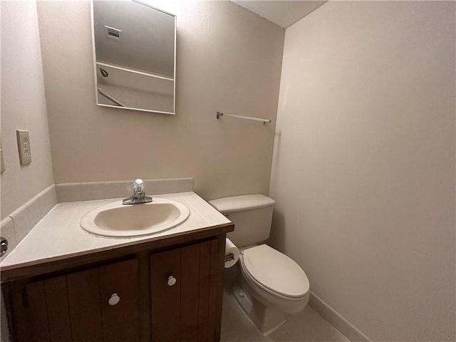 bathroom featuring visible vents, toilet, and vanity