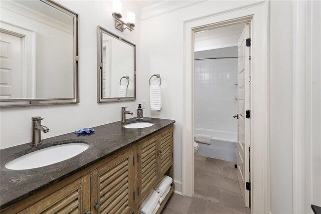 1626 Bruce Dr, Saint Simons Island, GA 31522 - bathroom featuring a sink, toilet, ornamental molding, and double vanity