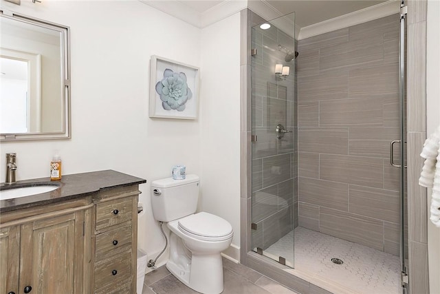 1626 Bruce Dr, Saint Simons Island, GA 31522 - bathroom featuring a shower stall, baseboards, toilet, ornamental molding, and vanity