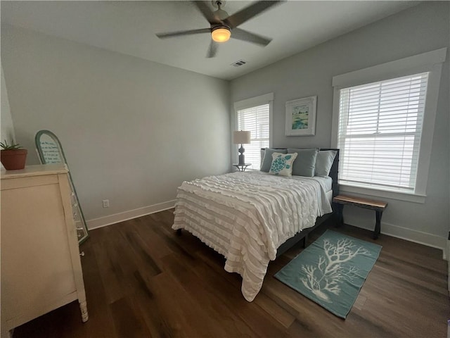 bedroom featuring dark wood finished floors, visible vents, and baseboards