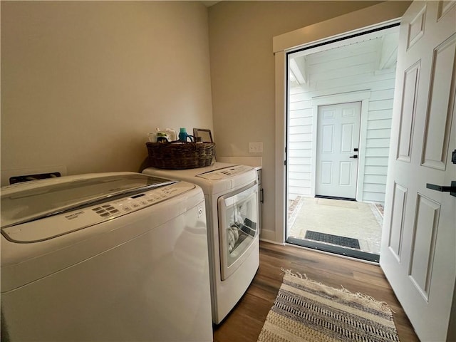 laundry room with washing machine and dryer and dark wood-style flooring