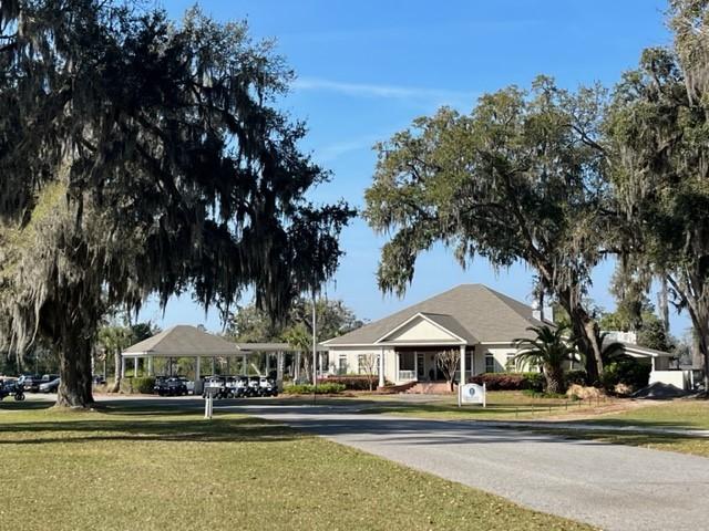 view of community with a carport and a lawn