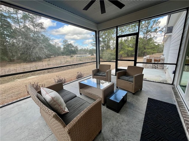 sunroom / solarium featuring ceiling fan