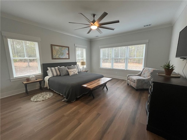 bedroom featuring ornamental molding, dark wood finished floors, and baseboards