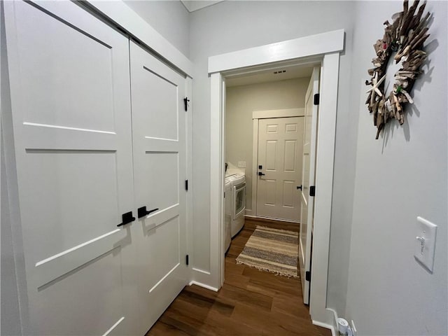 corridor featuring dark wood-style flooring and independent washer and dryer