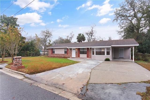 ranch-style house featuring a carport and a front yard