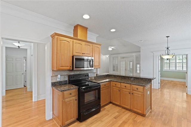151 Raymonds Grant Trce, Saint Simons Island, GA 31522 - kitchen with stainless steel microwave, electric range, a peninsula, light wood-style flooring, and recessed lighting