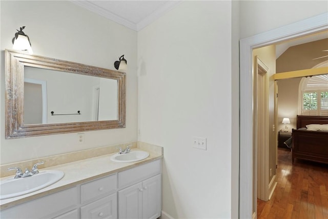151 Raymonds Grant Trce, Saint Simons Island, GA 31522 - bathroom featuring crown molding, double vanity, ensuite bath, and wood finished floors
