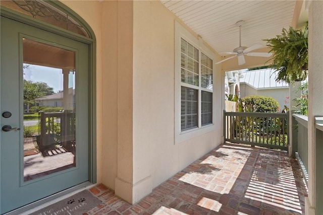 151 Raymonds Grant Trce, Saint Simons Island, GA 31522 - doorway to property featuring a ceiling fan, a porch, and stucco siding