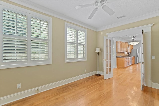 151 Raymonds Grant Trce, Saint Simons Island, GA 31522 - empty room with light wood-style flooring, ornamental molding, ceiling fan, and french doors