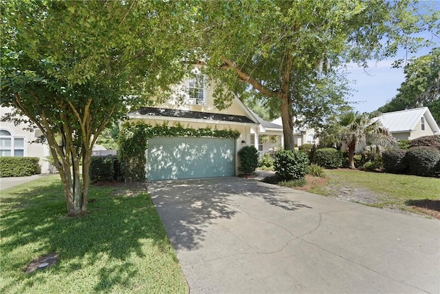 151 Raymonds Grant Trce, Saint Simons Island, GA 31522 - obstructed view of property with driveway, a front yard, a garage, and stucco siding