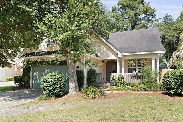 151 Raymonds Grant Trce, Saint Simons Island, GA 31522 - view of front of home featuring covered porch, driveway, a front lawn, and stucco siding
