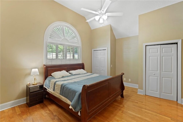 151 Raymonds Grant Trce, Saint Simons Island, GA 31522 - bedroom featuring lofted ceiling, light wood-style floors, a ceiling fan, and two closets