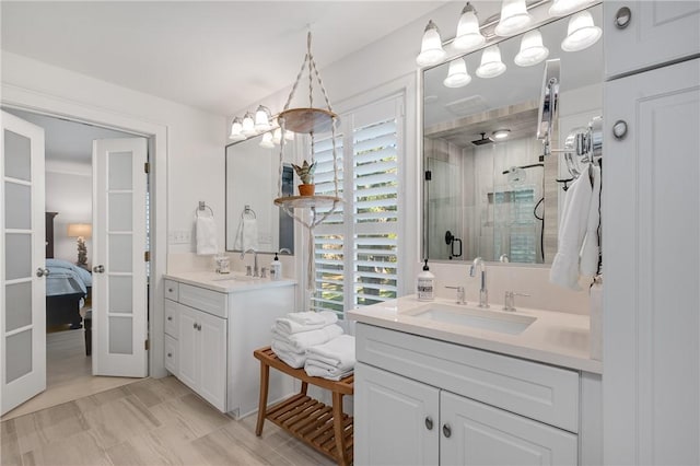 full bath with a stall shower, plenty of natural light, and a sink