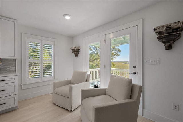 sitting room with light wood-type flooring and baseboards