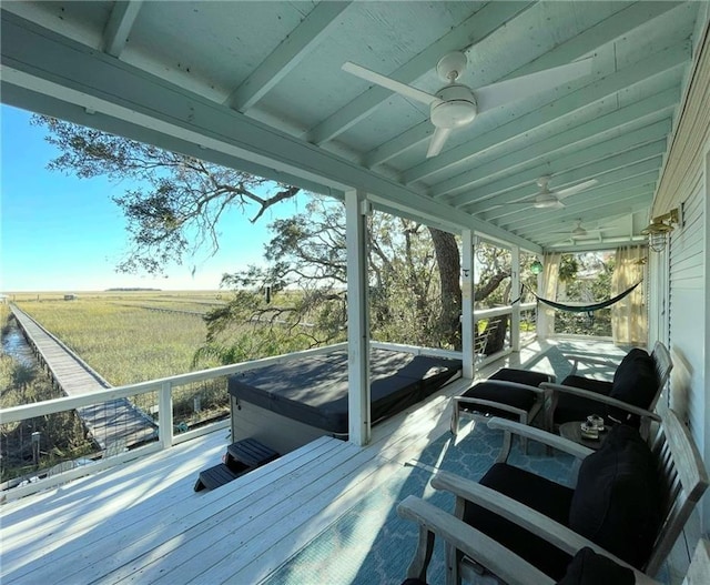 deck featuring ceiling fan and a rural view