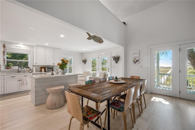 dining room featuring light wood finished floors, recessed lighting, and a healthy amount of sunlight