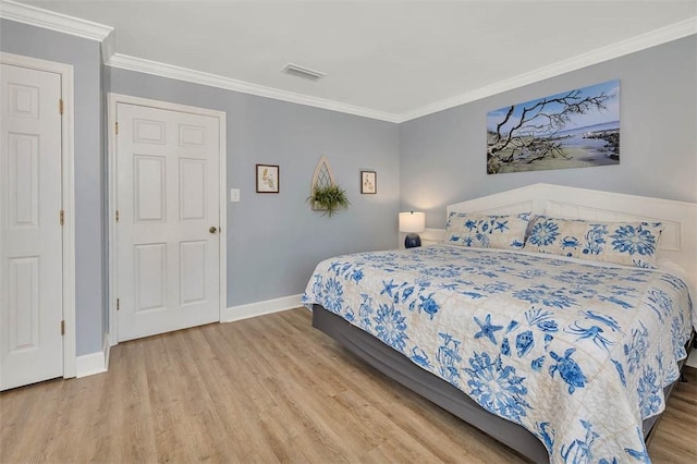 bedroom with light hardwood / wood-style flooring and ornamental molding