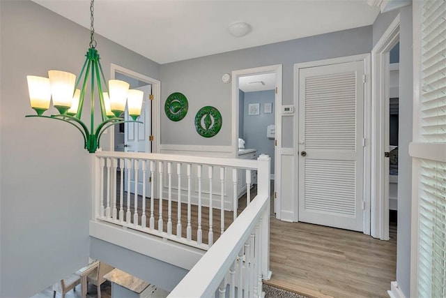 interior space with hardwood / wood-style floors and an inviting chandelier