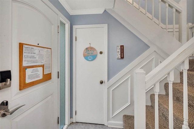 exterior space featuring light colored carpet and ornamental molding