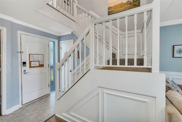 tiled entrance foyer with crown molding