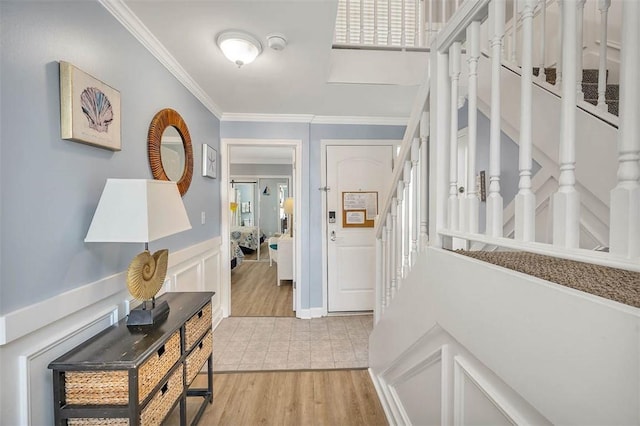 corridor featuring light wood-type flooring and ornamental molding