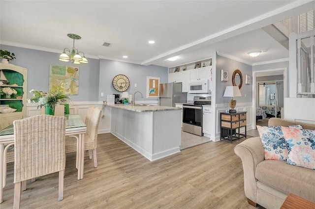 kitchen with stainless steel appliances, pendant lighting, light hardwood / wood-style flooring, a notable chandelier, and white cabinetry