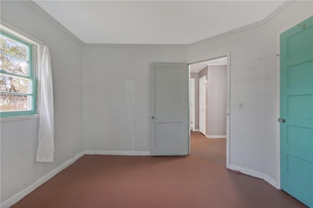 spare room featuring baseboards and ornamental molding