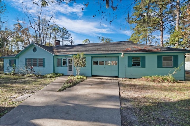 ranch-style home with a garage and a front lawn