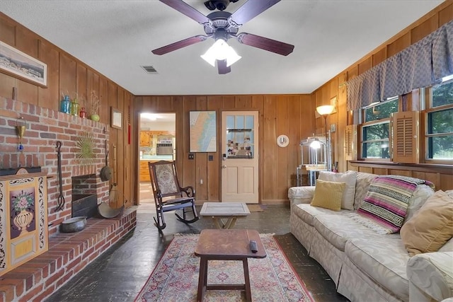 living room featuring ceiling fan and wooden walls