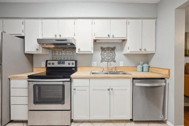 kitchen with ventilation hood, white cabinetry, stainless steel appliances, and sink