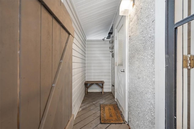 interior space featuring light hardwood / wood-style flooring and wooden walls