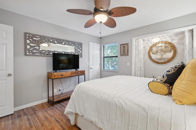 bedroom with hardwood / wood-style flooring and ceiling fan