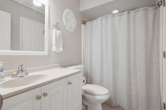 bathroom with tile patterned floors, vanity, and toilet