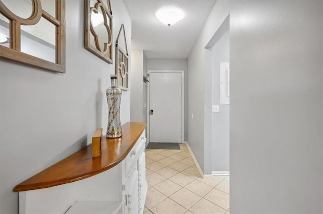 interior space with light tile patterned floors and a textured ceiling