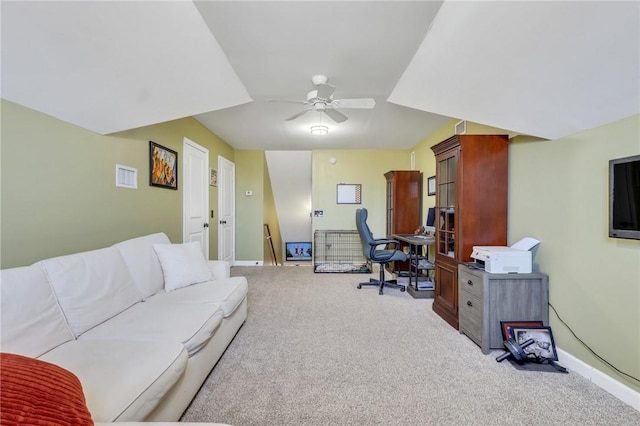 carpeted home office featuring ceiling fan