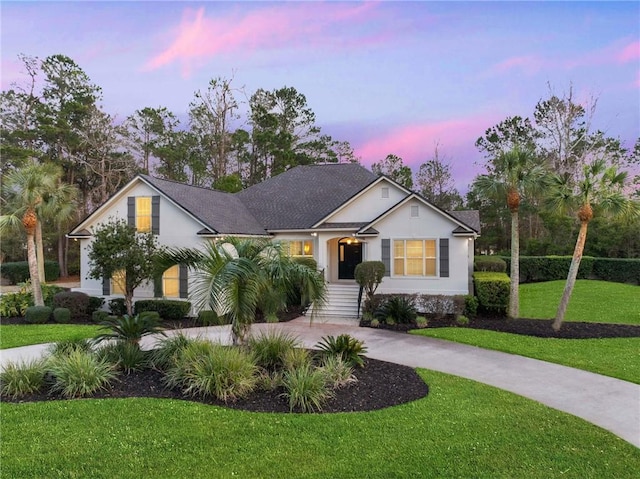 view of front of house with driveway and a front yard