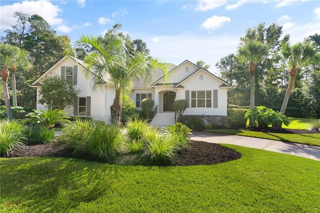 view of front of home featuring driveway, a front lawn, and stucco siding