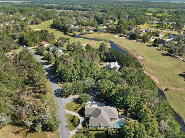 aerial view with a forest view and golf course view