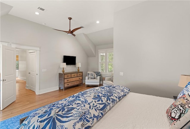 bedroom featuring hardwood / wood-style floors, ceiling fan, and lofted ceiling