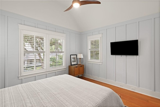 bedroom with hardwood / wood-style flooring, ceiling fan, and lofted ceiling